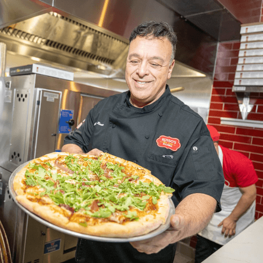 anthony russo holding a pizza