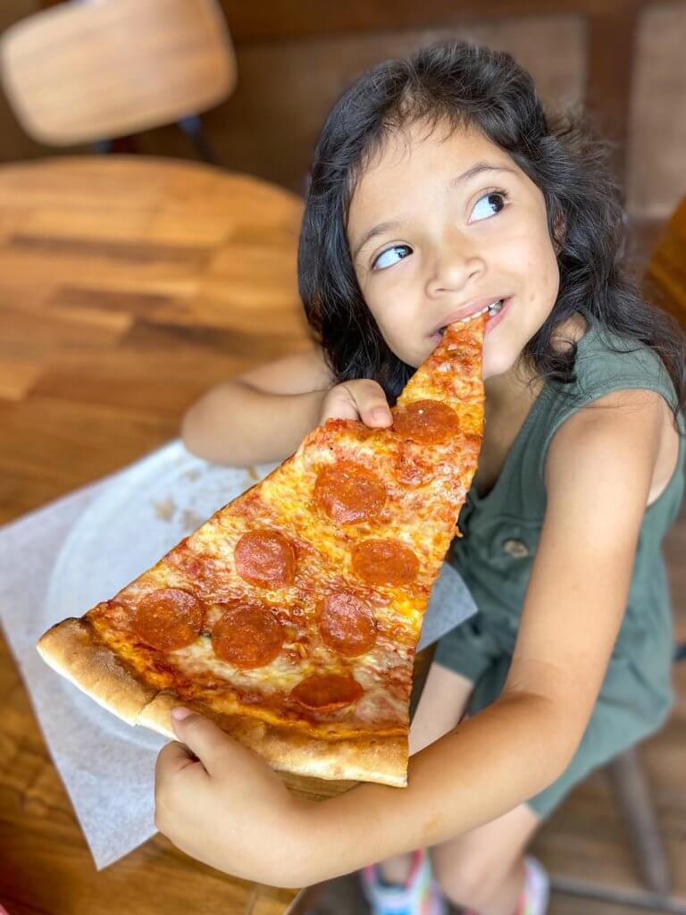 Child eating Russo's pizza slice
