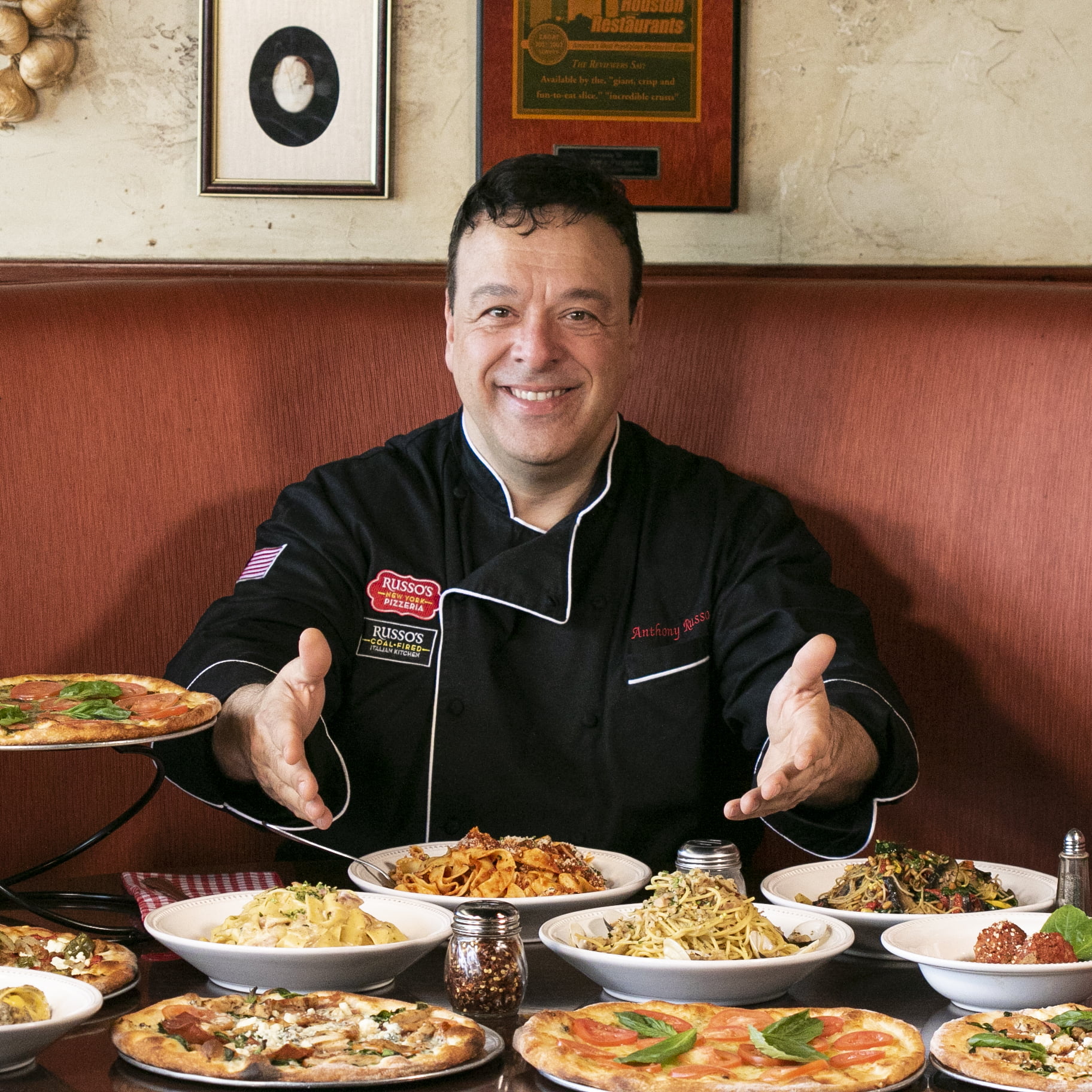 Anthony Russo with Table of Dishes