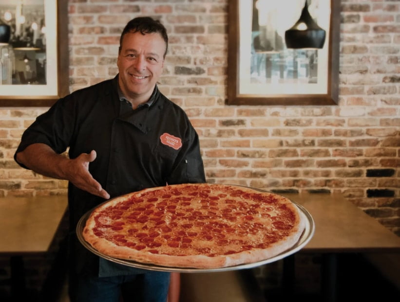 Anthony Russo Holding Pepperoni Pizza