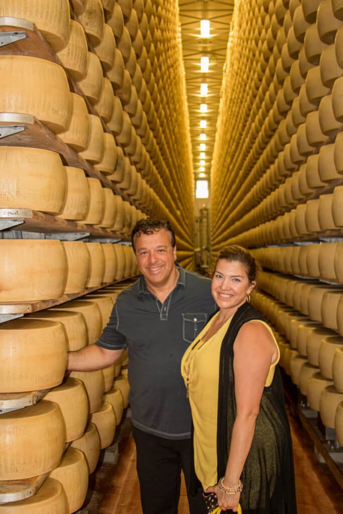 anthony and andrea with italian cheese wheels